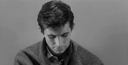 Anthony Perkins in Psycho, smiling creepily and looking right at you