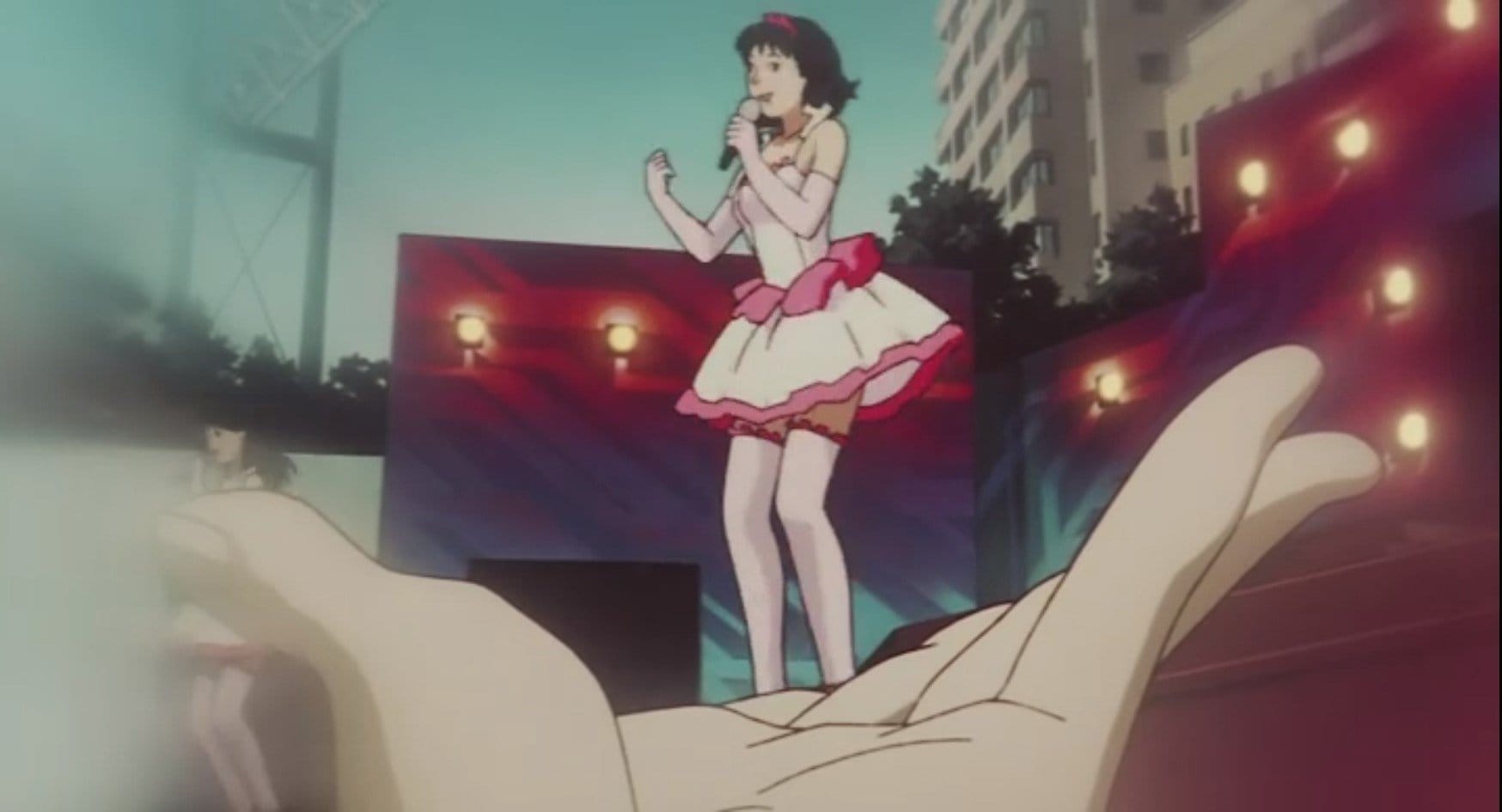 Still from Perfect Blue, from POV shot of a fan in the crowd holding his hand to make it look like Mima is standing in it
