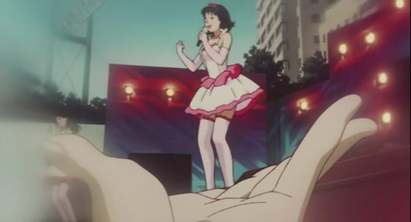 Still from Perfect Blue, from POV shot of a fan in the crowd holding his hand to make it look like Mima is standing in it