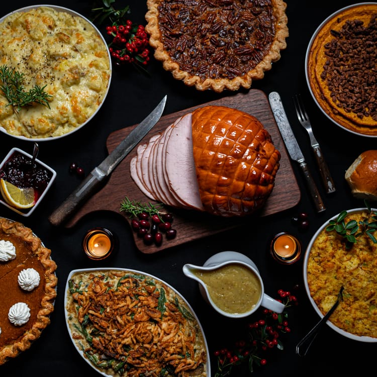 Carved meat surrounded by pies