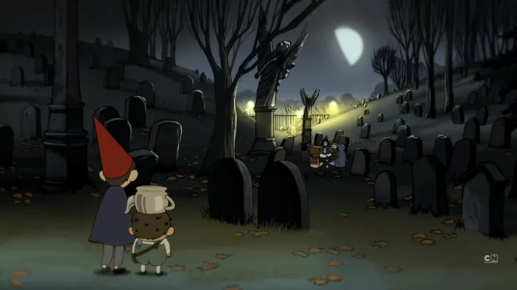 Two small boys, one with a red pointy had, one with a kettle on his head, survey a graveyard.